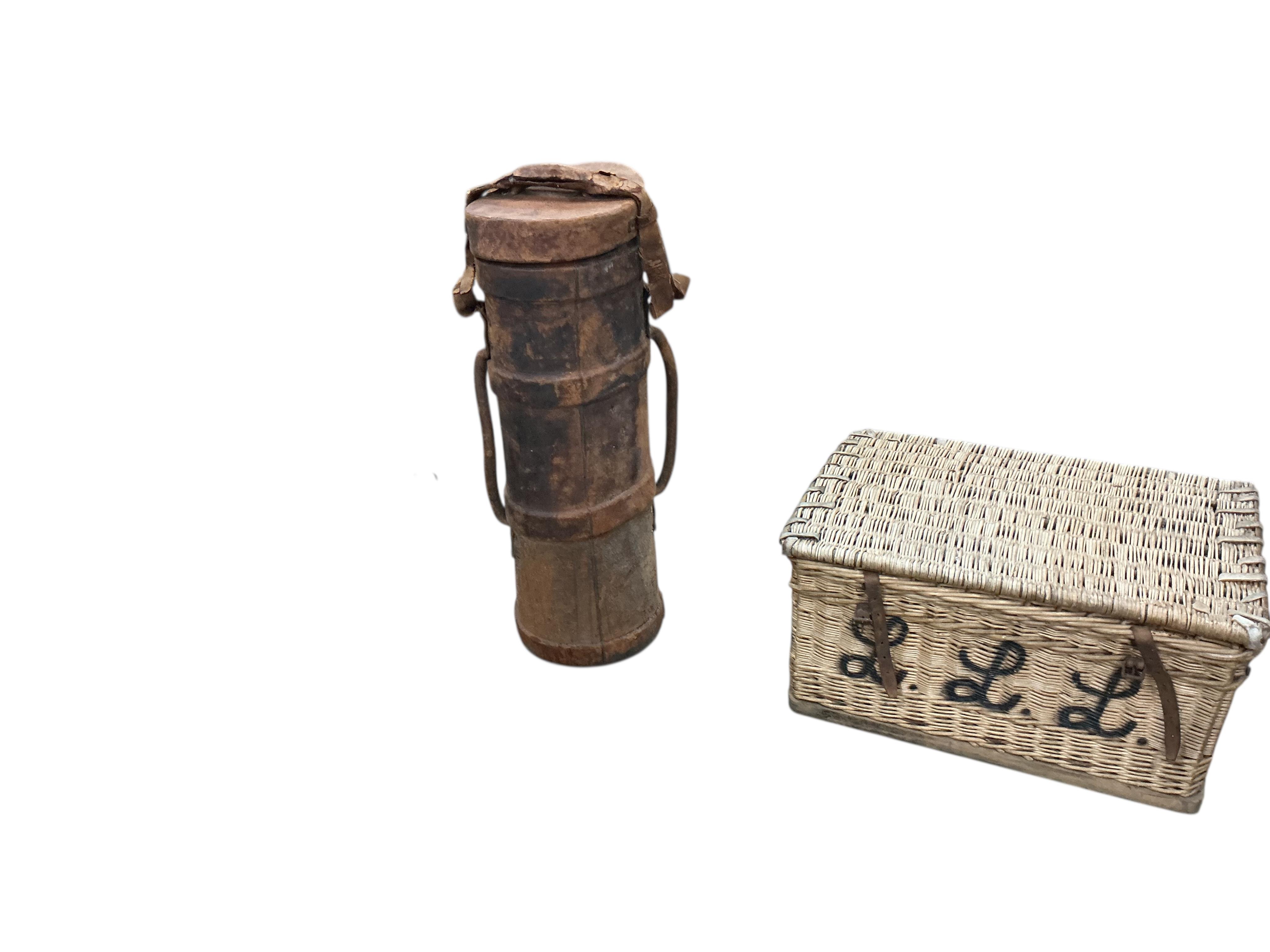 A WWI leather artillery shell case carrier, height 98cm, a wicker laundry hamper and a Revelation leather case